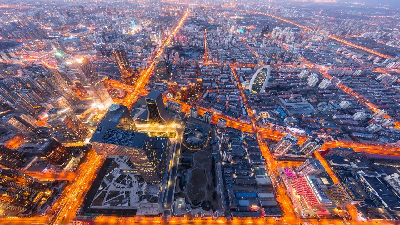 Aerial view of Beijing, China at dusk, featuring the city's modern skyline, illuminated streets, skyscrapers, and vibrant urban landscape in one of Asia's leading cultural and business destinations.