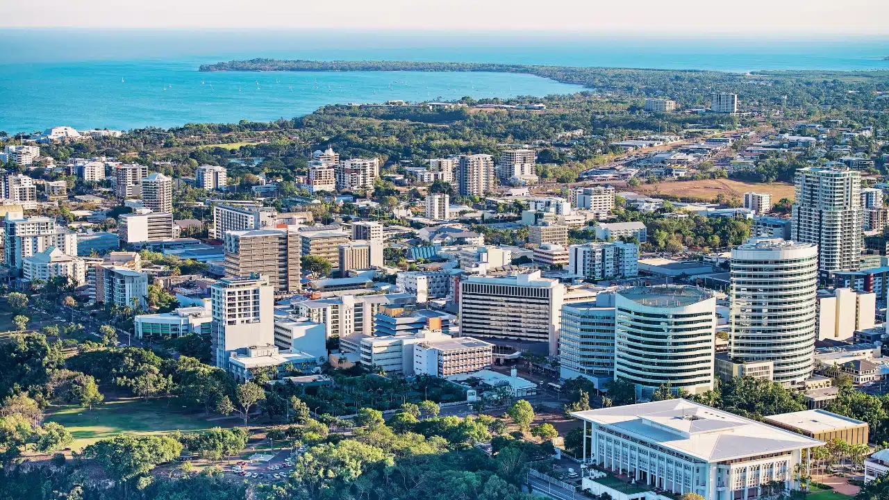 Aerial view of Darwin, Northern Territory, Australia, featuring the city's modern skyline, tropical landscape, and waterfront along the Timor Sea in Australia's Top End.